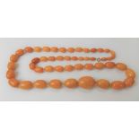 Butterscotch amber graduated oval bead necklace with 9ct gold clasp, the biggest bead width 25mm