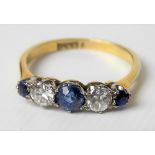 18ct gold diamond and sapphire set five stone ring, the circular stones with two diamonds of 0.