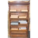 Early 20th Century oak sectional bookcase, the gallery top with dental moulding over five