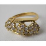 Modern 18ct gold hallmarked diamond three-section daisy head ring, each diamond of 0.04ct spread
