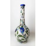 Iznik pottery bottle vase underglaze decorated with foliate scrolls upon a white ground, height 24cm