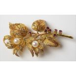 Attractive post-war 18ct gold pearl and ruby set open work floral brooch, the textured flowers and