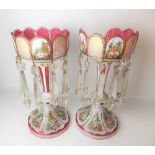 Pair of Victorian cranberry glass and white opaque table lustres with foliate painted enamel