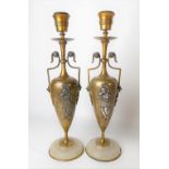 Pair of gilt lacquered bronze and silvered twin handled urn candlesticks with a circular onyx