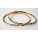 Pair of contemporary 9ct hallmarked gold foliate scroll engraved bangles, weight 28g approx.