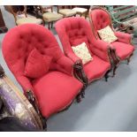 Three Victorian walnut framed buttonback upholstered armchairs, two with cabriole legs & casters