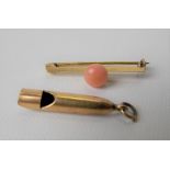 9ct gold coral set bar brooch, weight 2.5g approx; together with a yellow metal charm in the form of