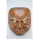 Large Japanese mask in carved wood with gilt eyes (23x27cm)