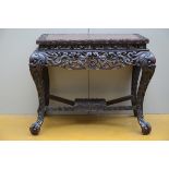 A sculpted Chinese table in hard wood, 19th century(*) (68x96x77cm)