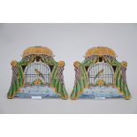 A pair of polychrome Dutch plaques 'bird cage' (25x21cm)