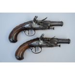 A pair of French gilt decorated silex pistols (19cm)