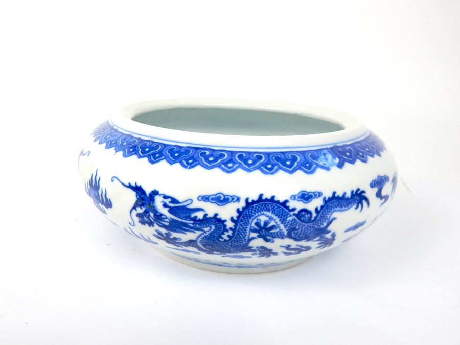 A Chinese blue and white bowl with dragon decoration, marks to base