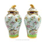 A pair of Copeland Spode famille rose vase and covers surmounted by dog of foe