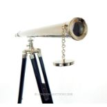 A contemporary chromed telescope on tripod