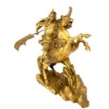 A gilt bronze sculpture of an oriental emperor on horseback