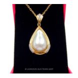 An 18 carat Yellow Gold Mabe Pearl and Diamond pendant necklace.