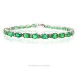 An Emerald and Diamond line bracelet.