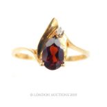 A 10 Carat Gold Pear Cut Garnet and Diamond Ring.