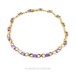 A 9 Carat Gold Kiss and Oval Cut Amethyst Bracelet.