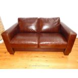 A Brown Two Seater Leather sofa.