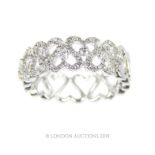 An 18 Carat White Gold Diamond Interlocking Heart Shaped Half Eternity Ring.