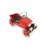 A Red Metal Retro Classic Pedal Car.