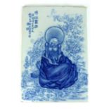 Chinese blue and white tile with a figure and text.