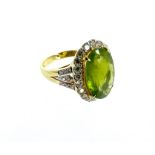 An 18 carat Yellow gold Peridot and Diamond cluster ring of 7.5 carats. Size: O, 5.7 grams
