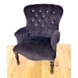 A Black Upholstered Button Back Armchair.