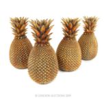 Four Gilt Ornamental Pineapples.