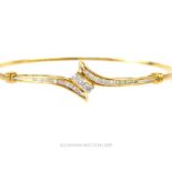 A 10 Carat Gold Baguette and Brilliant cut Diamond Bangle.