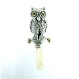 A silver Babies Rattle In the Form Of an Owl.