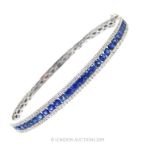 An 18 Carat White Gold Sapphire And Diamond Bangle.