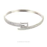 A Silver And Cubic Zirconia Bangle In The Form Of A Belt.