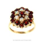 A 9 Carat Gold Garnet and Opal Dress Ring.