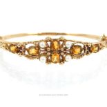 A Vintage 9 carat Gold Citrine and Seed Pearl Faceted Bangle with Safety Chain.