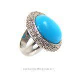 An 18 Carat White Gold Ring The Central Turquoise Surrounded by Diamonds.