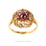 A Gold And Seven Stone Ruby Cluster Ring.