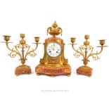 A Brass And Marble Clock Suite With A Floral Finial