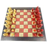 A Chess Set With Red And White Chess Pieces.