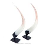 A Pair Of White Hand Blown Glass Horns.