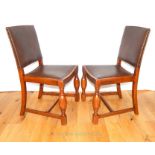 A Pair Of Leather And Wood Upholstered Chairs.