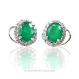 An 18 Carat Emerald Earrings With Diamonds.