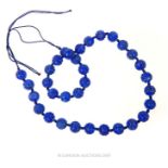 A Chinese Carved Lapis Bead Necklace.