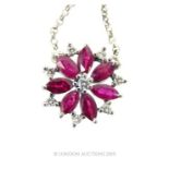 An 18 Carat Diamond And Ruby Pendant With Chain.