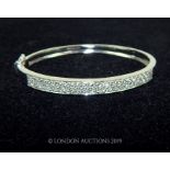 An 18 Carat White Gold Bangle.