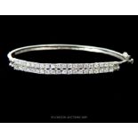 A Silver And Cubic Zirconia Two Row Bangle.
