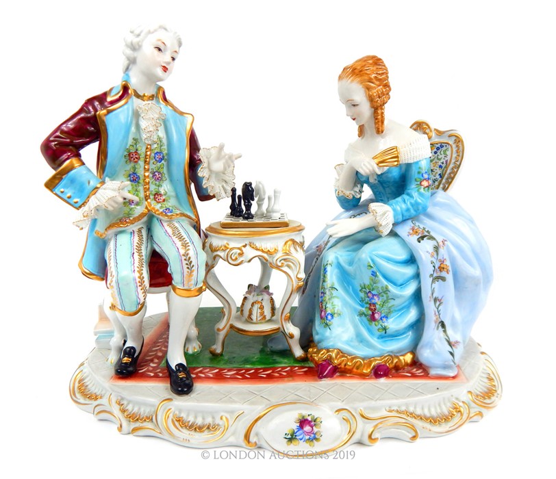 A large Meissen Diorama Of A Couple Playing Chess.