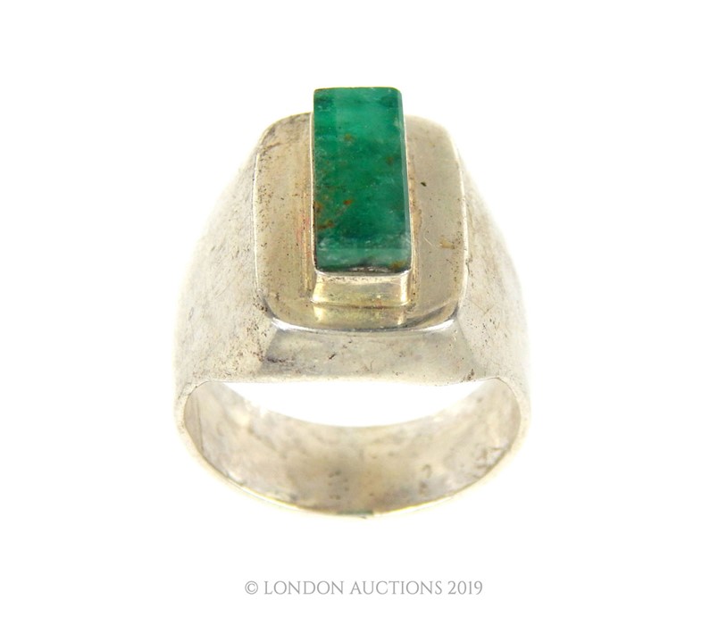 A Large Rectangle Cut Emerald In White Metal/Silver Ring.