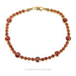 A 14 Carat Gold Madagascar Garnet Tennis Bracelet.